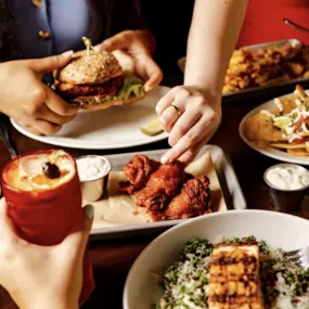 table full of food: Wings, Salad, Veggie Burger