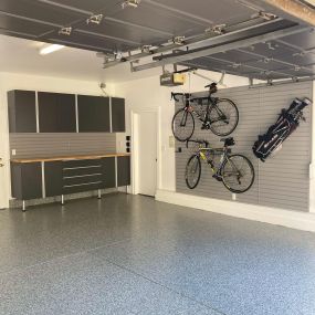 Custom cabinets and slatwall w/ epoxy flooring by Premier garage
