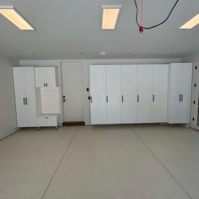 White Cabinets, white slatwall, custom epoxy flooring by Premier Garage of the Bay Area