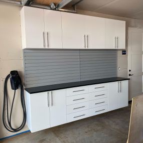 Custom Cabinet with countertop and slatwall by Premier Garage