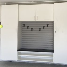 Custom bench with cabinets by Premier Garage