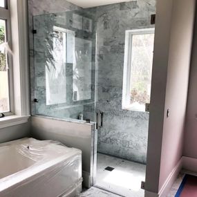 Check out the notched, #frameless shower enclosure we built for this bathroom remodeling project.