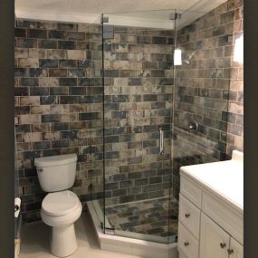 Our frameless glass shower really opens up this guest bathroom remodeling project.