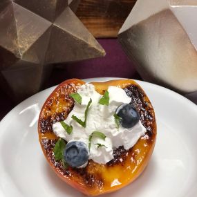 Grilled Peach with Whipped Cream, Blueberries, and Mint