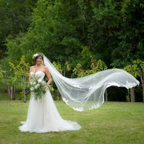 Bride posing in her lovely wedding dress in front of the vineyard