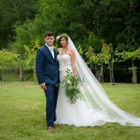 Beautiful bride and groom posing on the vineyard grounds.