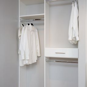 Laundry room organization with multiple hanging options.