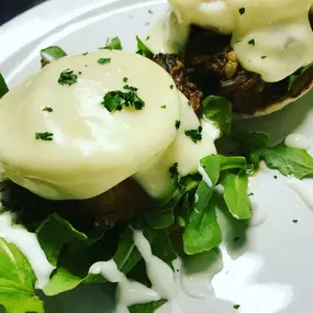 The Braised Short Rib Benedict with arugula, horseradish crema and Swiss cheese Mornay