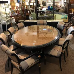 Glamorous Black Lacquer and Burled Wood Marge Carson Dining Table protected by glass with Eight Upholstered Chairs accented in gold