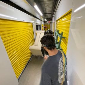 Photo of Aaron Movers moving furniture in a storage facility.