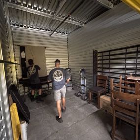 Aaron Movers employees inside of a storage unit.
