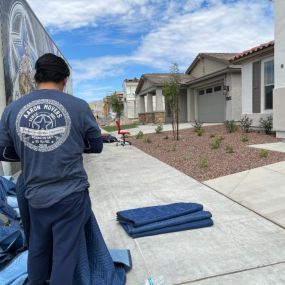 Aaron Movers employee folding padded protective blankets.