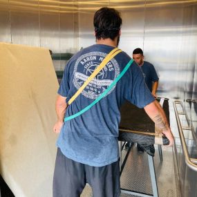 Aaron Movers employees using a storage facility elevator.