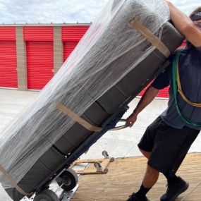 Aaron Movers employee moving a couch