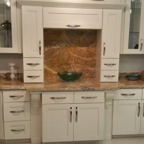 Stone International showroom with off-white cabinets and quartz countertop.