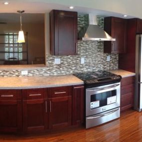 Kitchen with mocha cabinets and granite countertop.