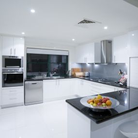 Modern kitchen with white cabinets and quartz countertop.