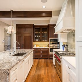 Kitchen with white cabinets and granite countertop.