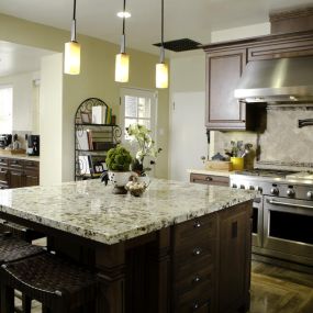 Kitchen with espresso shaker cabinets and granite countertop.