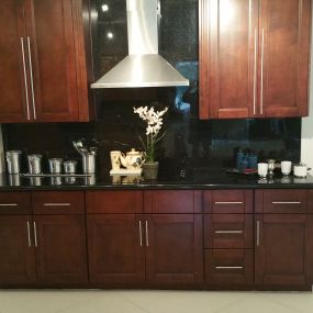 Stone International showroom kitchen with mocha cabinets and quartz countertop.