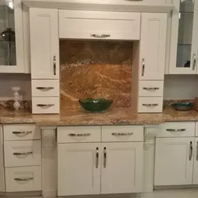 Stone International showroom with off-white cabinets and quartz countertop.