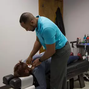 Dr. Bailey using his chiropractic techniques on a patient at Spine in Motion Chiropractic Rehab