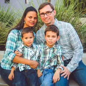 Dr. Spurling and Viviana, dental assistant, and their family.