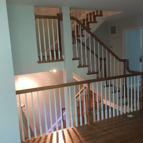 All the wrought iron handrails were replaced with new newel posts, handrails and pristine white balusters.