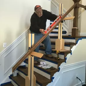 Owner helping to measure the angle for cutting. Note the two “deadmen” that are hold up the rail.