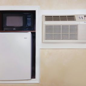 A microwave, a small fridge, and an AC unit