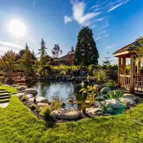 A Greenhaven Landscapes design customer's Vancouver WA beautiful yard with outdoor structure, water feature and pathway