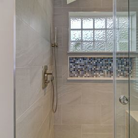 Replaced garden tub with shower. Covered part of the window with a beautiful tile shower niche.