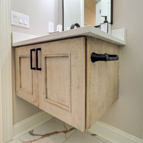 A floating vanity in matte, natural maple