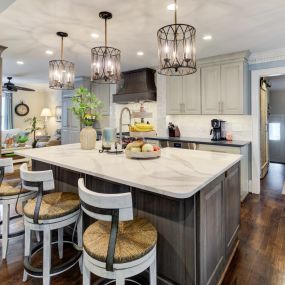 Contrasting stained island and hood complements the white kitchen in Masonboro.