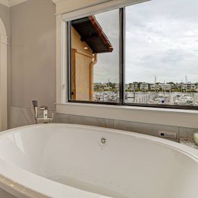 Reconfigured bathroom by moving the shower and adding the free-standing tub. Lovely looking over the marina.