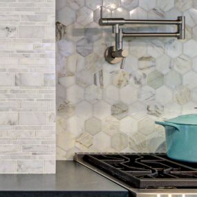 Natural marble tile backsplash detail in Masonboro kitchen.