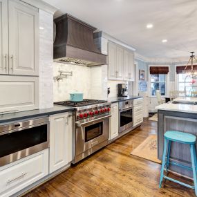 A curved chimney hood adds style and elegance to this kitchen in Masonboro.