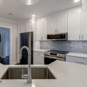 Fresh white kitchen with blue 3x12 subway tile