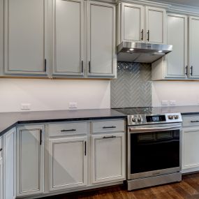 Quartz Backsplash with Herringbone Tile Accent