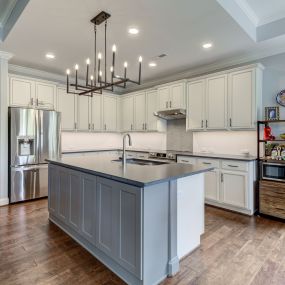 Wall base cabinets add storage to island with cut down bar