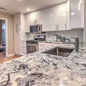 Contemporary White Kitchen Remodel with Granite Countertop