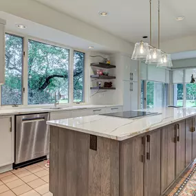 Modern Kitchen in Landfall with Slim Shaker frameless Showplace EVO cabinets- white perimeter and stained wood island, quartz backsplash