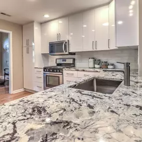 Contemporary White Kitchen Remodel with Granite Countertop