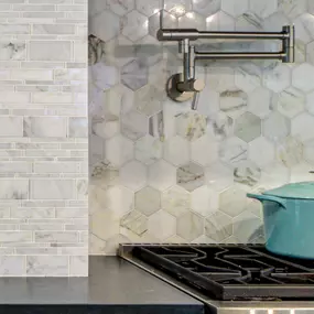 Natural marble tile backsplash detail in Masonboro kitchen.