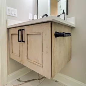 A floating vanity in matte, natural maple