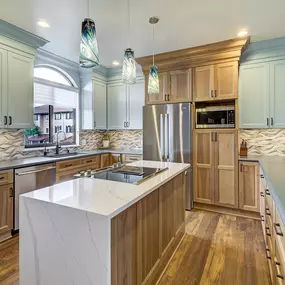 New kitchen in Carolina Beach with hickory cabinets and ornate glass mosaic backsplash.