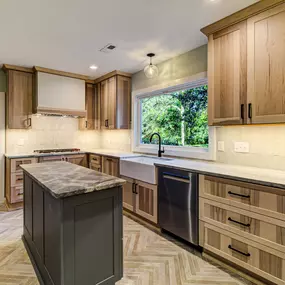 Showplace Hickory cabinetry, rustic tile backsplash, contrasting painted hood and island