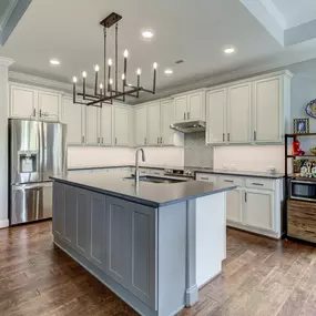 Wall base cabinets add storage to island with cut down bar