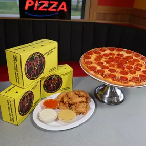 Pepperoni pizza and chicken wings with dipper sauces