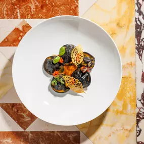 Chef’s Signature: Black ravioli with cuttlefish, caciucco sauce, sun-dried tomato pesto and potatoes